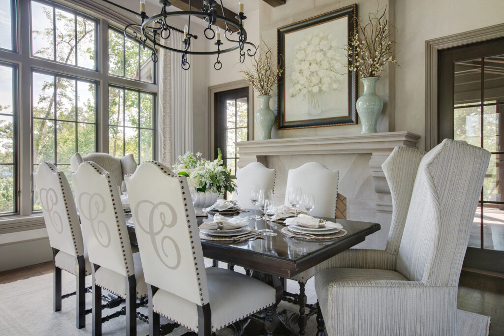 Traditional dining room design with fireplace lighting and custom artwork